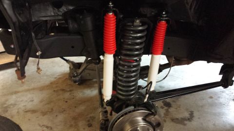1978 Ford Bronco - Close-up view of a vehicle's suspension system, showing shocks, springs, and brake components.