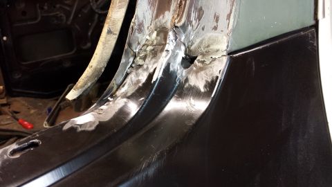 1978 Ford Bronco - Detail of body panel repair work, showing metal fabrication and grinding.