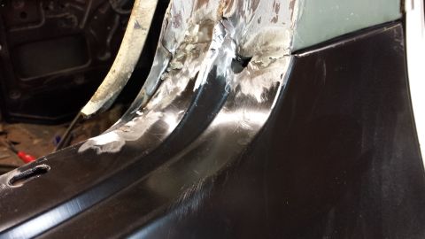 1978 Ford Bronco - Metal panel repair work in progress, showing grinding and welding on rusted areas.