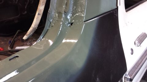1978 Ford Bronco - Close-up of a vehicle's interior frame, revealing rust and damage, with a partial view of a door.