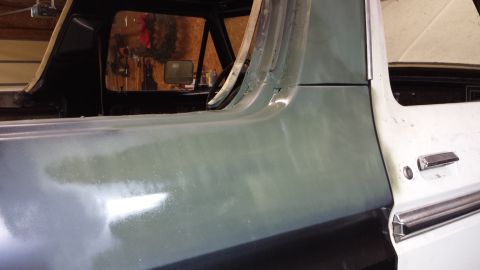 1978 Ford Bronco - Side view of a 1978 Ford Bronco, showing primer on the rear quarter panel and the door handle on the front door.