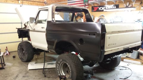 1978 Ford Bronco - This Ford Bronco is undergoing repairs in a garage, with its hood up and one quarter panel in primer.