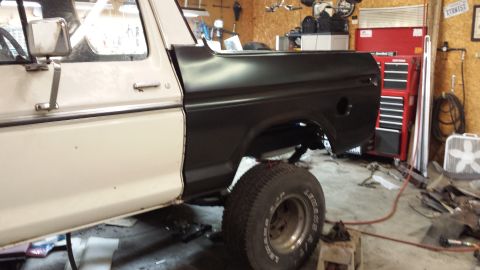 1978 Ford Bronco - This 1978 Ford Bronco is undergoing work in a garage, showing its side profile with contrasting white and black paint.
