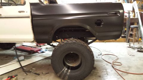 1978 Ford Bronco - A 1978 Ford Bronco is shown in a workshop with its rear quarter panel undergoing repair.