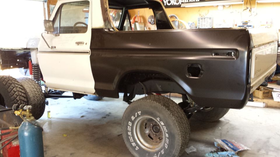 1978 Ford Bronco, white and black, undergoing repairs, 3q-front view