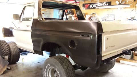 1978 Ford Bronco - Bodywork in progress on a 1978 Ford Bronco, showing primer on the rear quarter panel.