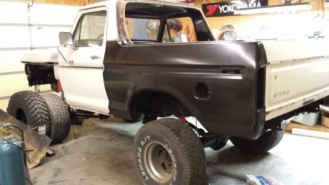 1978 Ford Bronco - This 1978 Ford Bronco is in a garage, partially disassembled and lifted with large tires.