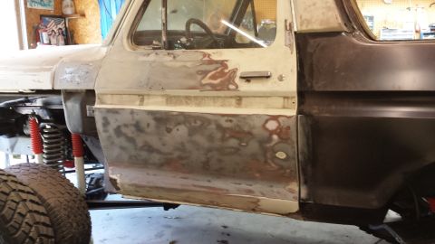 1978 Ford Bronco - Driver's side of a 1978 Ford Bronco undergoing body repair and preparation for paint.