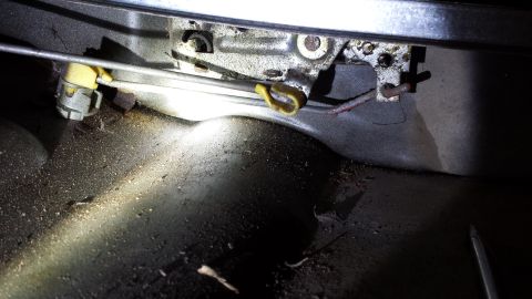 1978 Ford Bronco - Interior view of a car's door latch mechanism, showing linkage and housing.
