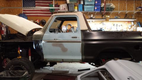 1978 Ford Bronco - This 1978 Ford Bronco is in a garage, appearing to be undergoing repairs or restoration.