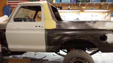 1978 Ford Bronco - This 1978 Ford Bronco is in a garage, showing primer and bodywork in progress.