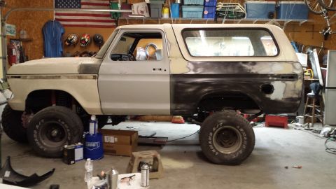 1978 Ford Bronco - This 1978 Ford Bronco is in a garage, showing primer and bodywork as it undergoes repairs.