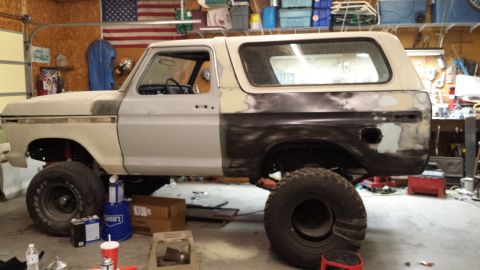1978 Ford Bronco - This 1978 Ford Bronco is in a garage, showing its side profile with bodywork in progress.