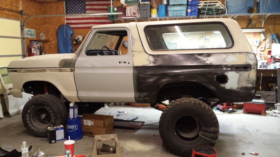 1978 Ford Bronco side view, undergoing bodywork in a garage