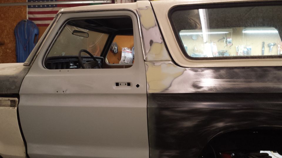 1978 Ford Bronco side view showing bodywork and primer on the passenger side