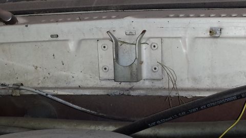 1978 Ford Bronco - Close-up of a bracket and hose in the engine bay, with Supermotors branding visible on the hose.