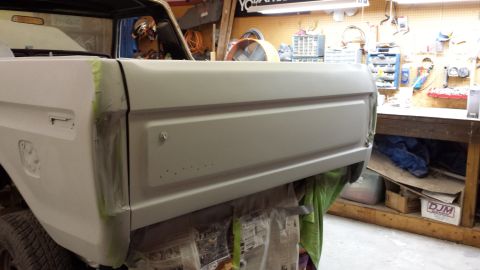 1978 Ford Bronco - The rear of a vehicle is shown in a garage, undergoing preparation for a paint job.