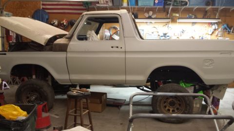 1978 Ford Bronco - Side view of a 1978 Ford Bronco undergoing restoration in a workshop.
