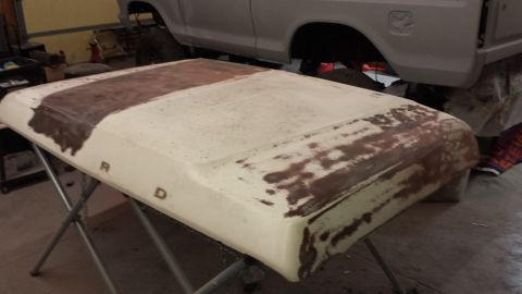 1978 Ford Bronco - A vehicle hood, possibly for a Ford, is shown with primer and rust damage.
