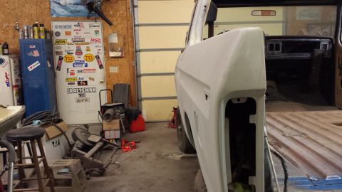 1978 Ford Bronco - The interior of a classic Ford Bronco is visible, with the driver's side door removed during a restoration project.