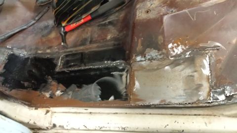 1978 Ford Bronco - Floor pan repair work in progress, showing rusted metal and new patches.