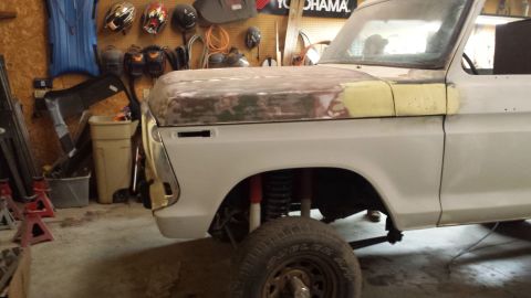 1978 Ford Bronco - The front section of a 1978 Ford Bronco is shown in a garage, with the hood prepped for paint.