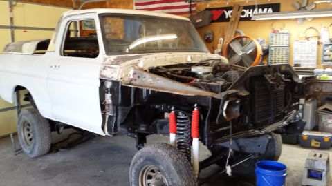 1978 Ford Bronco - This 1978 Ford Bronco is in a garage, missing its front clip and undergoing repairs.