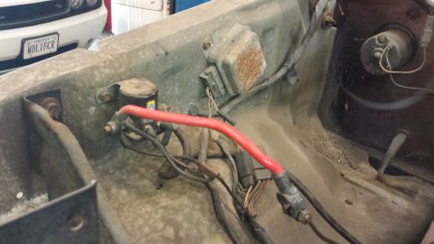 1978 Ford Bronco - Close-up view of engine bay wiring and electrical components, including a prominent red cable.