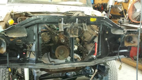 1978 Ford Bronco - The front end of a 1978 Ford Bronco has been removed, exposing the engine and surrounding components.