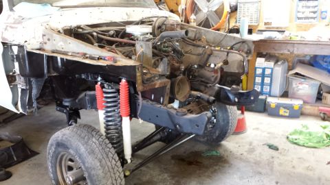 1978 Ford Bronco - This vehicle is in a state of disassembly, with the engine bay open and suspension components visible.