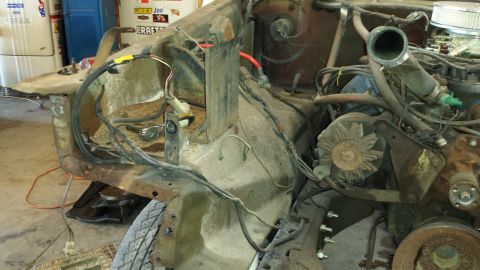 1978 Ford Bronco - The engine bay of a 1978 Ford Bronco shows significant disassembly and wiring work.