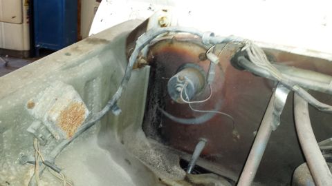 1978 Ford Bronco - The engine bay shows a complex network of wires and hoses, with visible signs of age and wear.