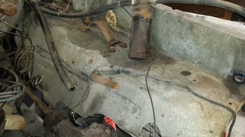 1978 Ford Bronco - Close-up view of engine bay components, showing hoses, wires, and metal parts.