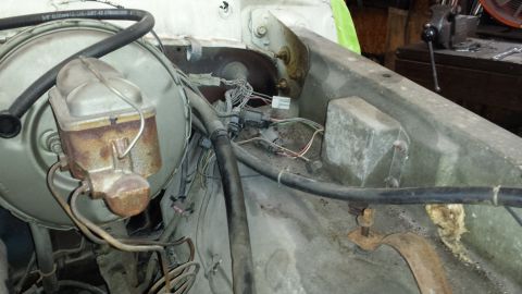 1978 Ford Bronco - Close-up of the engine bay of a 1978 Ford Bronco, focusing on the brake booster and associated wiring.