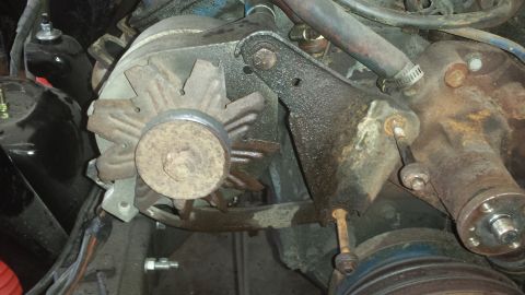 1978 Ford Bronco - Close-up view of engine components, including an alternator and various hoses and wires.