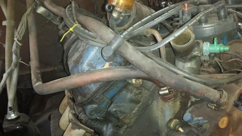 1978 Ford Bronco - A detailed view of the engine compartment, showing various hoses and mechanical parts.