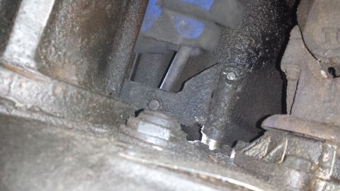 1978 Ford Bronco - Close-up view of a greasy engine component with visible blue and black parts.