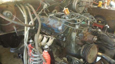 1978 Ford Bronco - Close-up view of a V8 engine, showing various hoses, wires, and mechanical components.