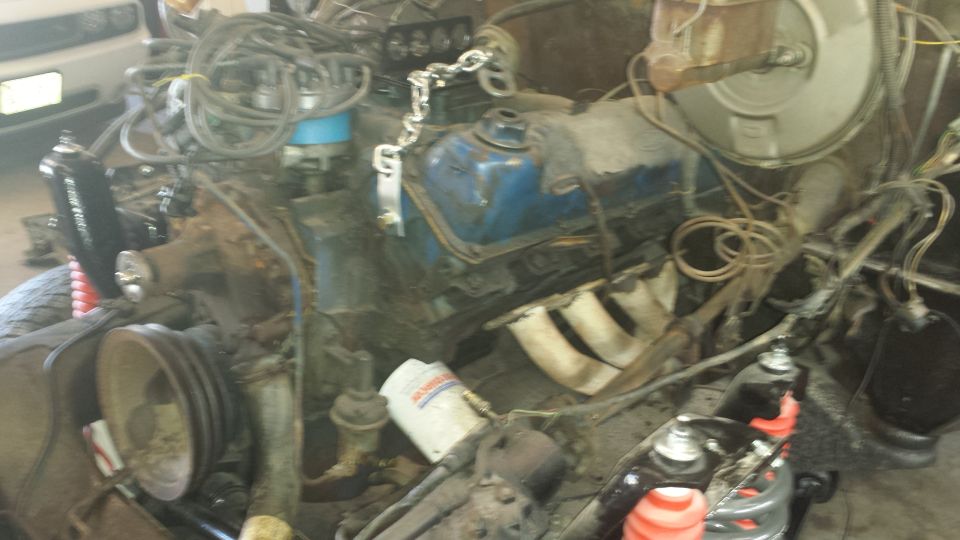 Engine bay with blue valve covers and exhaust manifolds