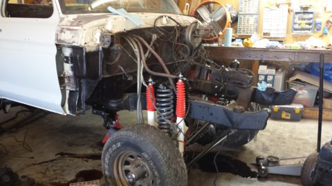 1978 Ford Bronco - This Ford Bronco is in a workshop, undergoing repairs with its front end dismantled.