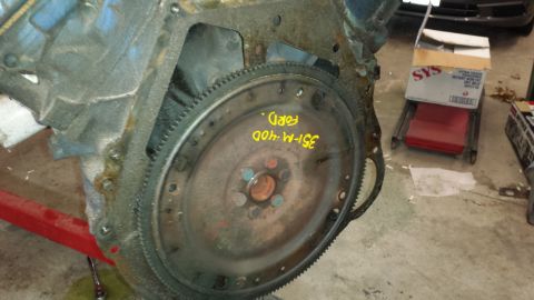 1978 Ford Bronco - Close-up of a Ford engine block and flywheel with identifying markings.