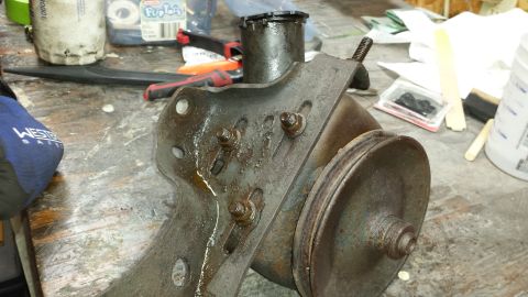 1978 Ford Bronco - A close-up view of a power steering pump, likely removed for repair or replacement.