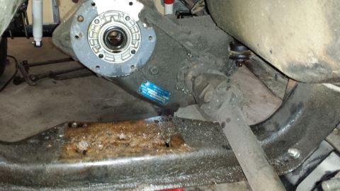 1978 Ford Bronco - Underside view of a vehicle's drivetrain components, including the transfer case and suspension.