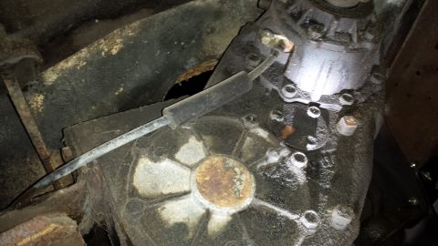 1978 Ford Bronco - Close-up view of a vehicle's transfer case, showing mechanical components and signs of wear.