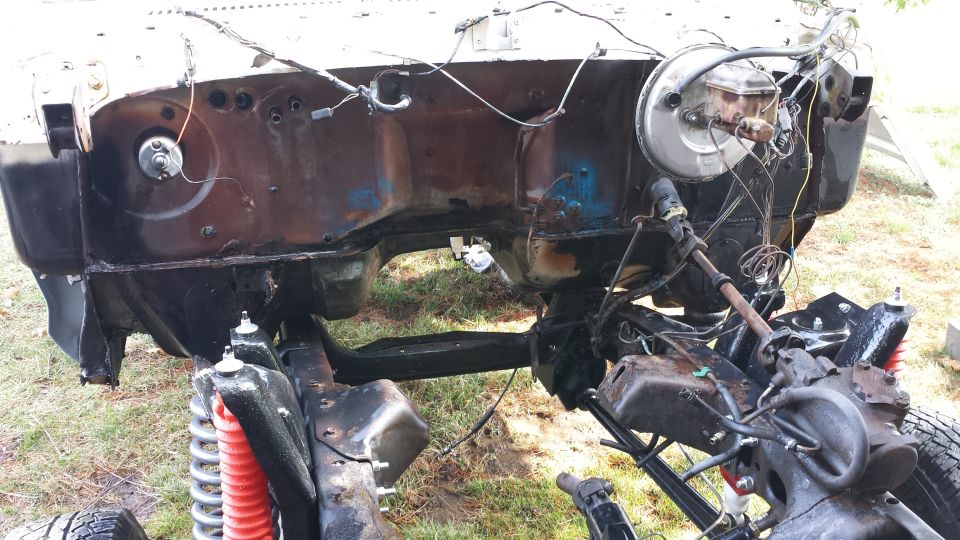 vehicle frame with engine bay exposed, brake booster visible