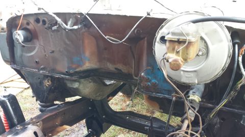1978 Ford Bronco - Close-up view of the engine bay firewall and brake booster assembly.