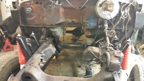 1978 Ford Bronco - The vehicle's frame and engine compartment are exposed, indicating a significant repair or rebuild process is underway.