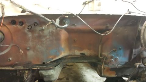 1978 Ford Bronco - The engine bay firewall shows significant rust and exposed wiring.