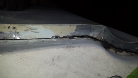 1978 Ford Bronco - This image shows a section of a vehicle's bodywork that has been repaired, with evidence of welding and filler.
