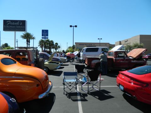 1979 Ford Bronco - A variety of vehicles are on display at an outdoor car show under a clear blue sky.